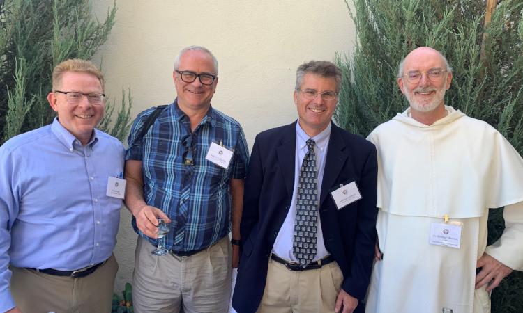 Four conference attendees pose for a picture