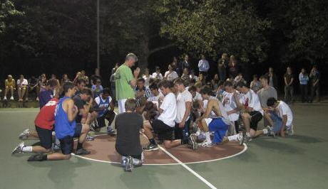 Fr. Sebastian leads a pre-game prayer