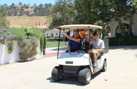 Lee arrives in a golf cart