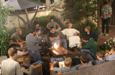 Fr. Sebastian speaks with students in the men's residence ha