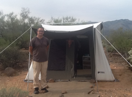 Mark Byerly poses outside his tent in Arizona