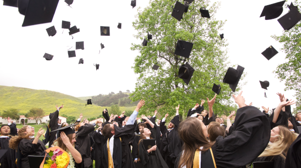 Graduates toss their mortarboards