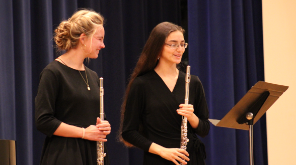 Two prepare to play a flute duet
