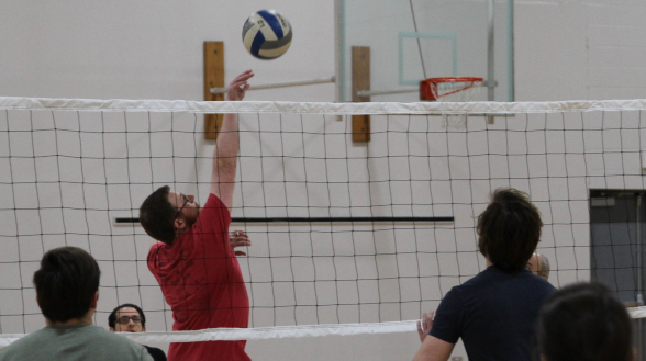 One about to hit the ball over the net