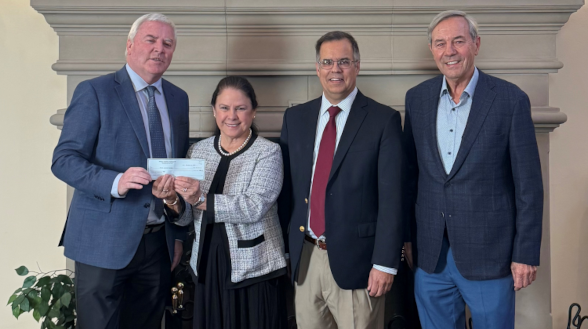 Maureen Rawlinson, a trustee of the Fritz B. Burns Foundation, presents a check for $7 million to President Paul J. O’Reilly, Vice President for Advancement John J. Goyette, and Dieter Huckestein, a member of the Thomas Aquinas College Board of Governors.