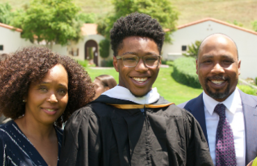 Parents and graduate at commencement.