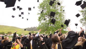 Graduates toss their mortarboards