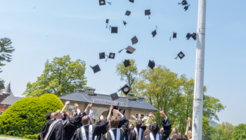 Graduates toss their caps