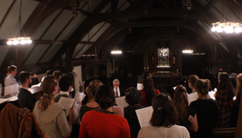 The choir sings in the darkened church