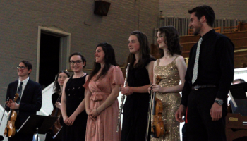 Musicians bow at the end of a performance