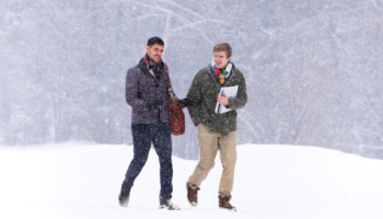 Students walk in the snow