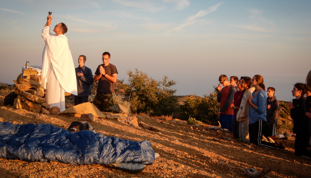 Fr. Paul offers Mass at dawn atop the hills on a hiking trip