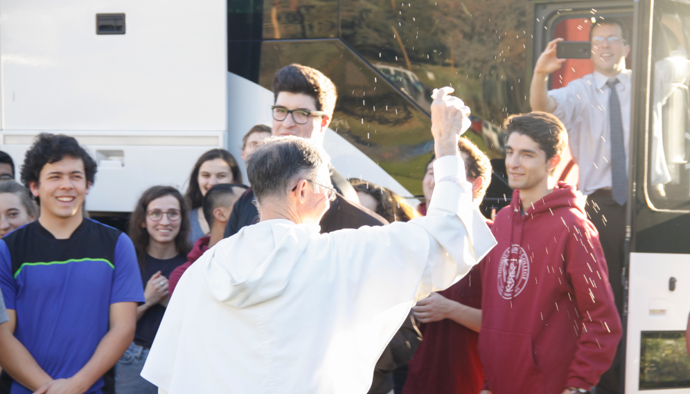 Fr. Paul blesses students as they depart for the 2019 Walk for Life