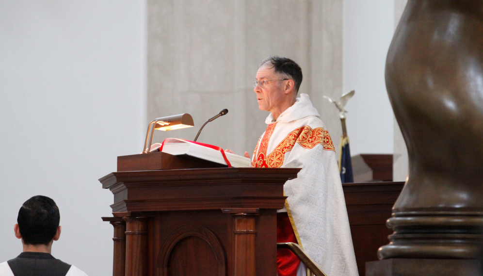 Fr. Paul reads the Gospel at the St. Thomas Day Mass, 2019