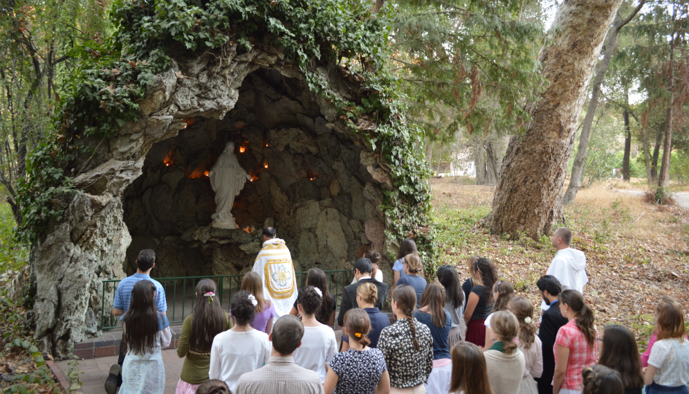Fr. Paul leads students in a Rosary at the Grotto