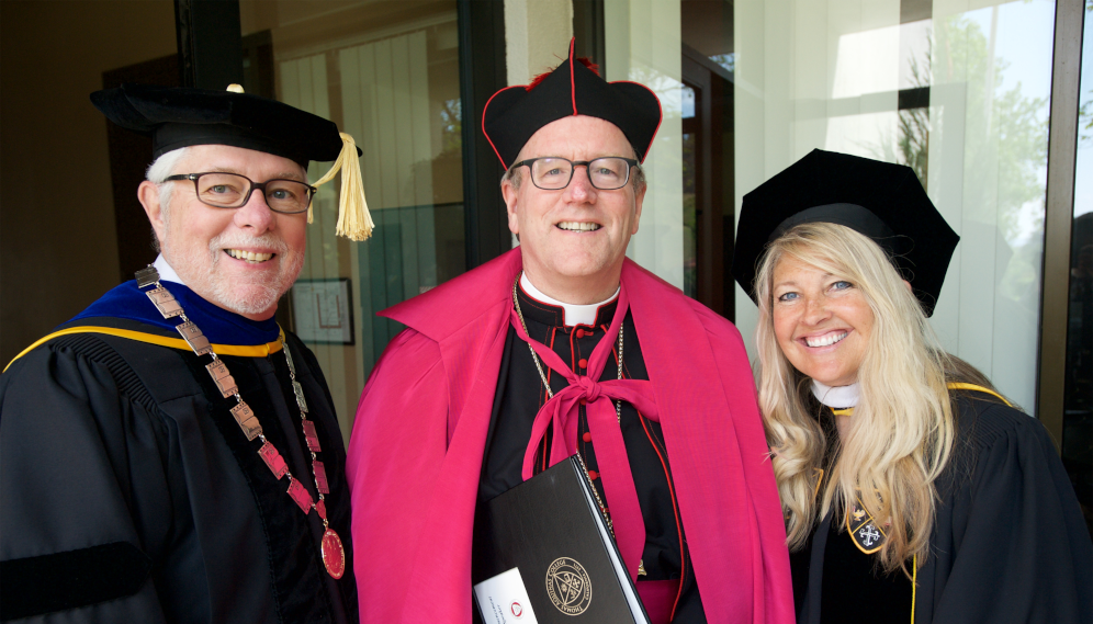 President Michael F. McLean, Bishop Barron, and College Governor Angela Connelly at Commencement 2019