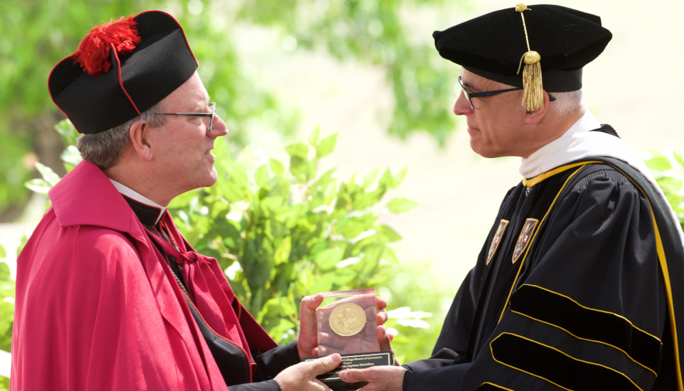 Chairman of the Board of Governors Scott Turicchi awards Bishop Barron the Saint Thomas Aquinas Medallion at Commencement 2019.