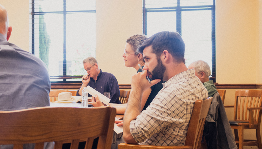 Closeup: four tutors at one end of the table