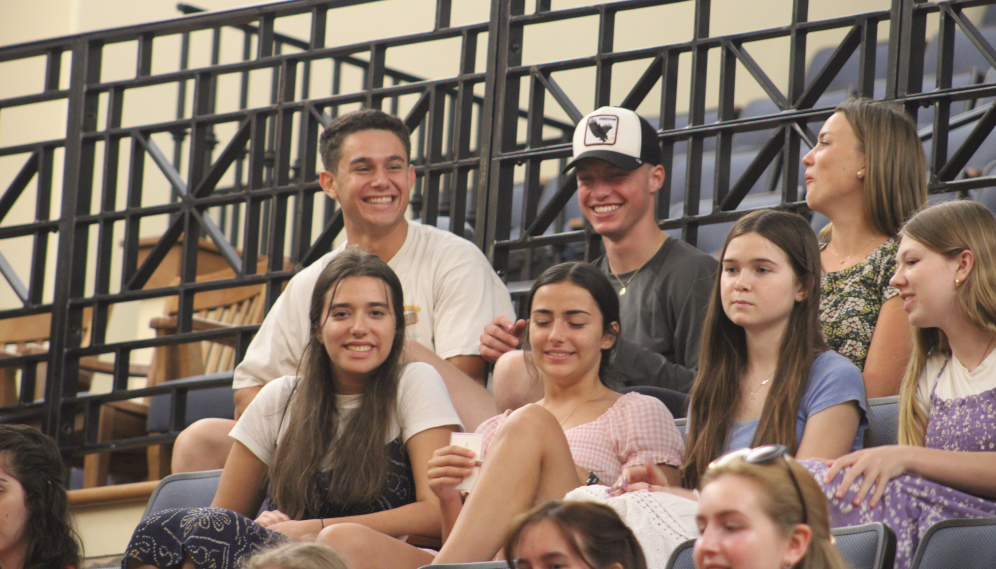 Students near the rear of the auditorium