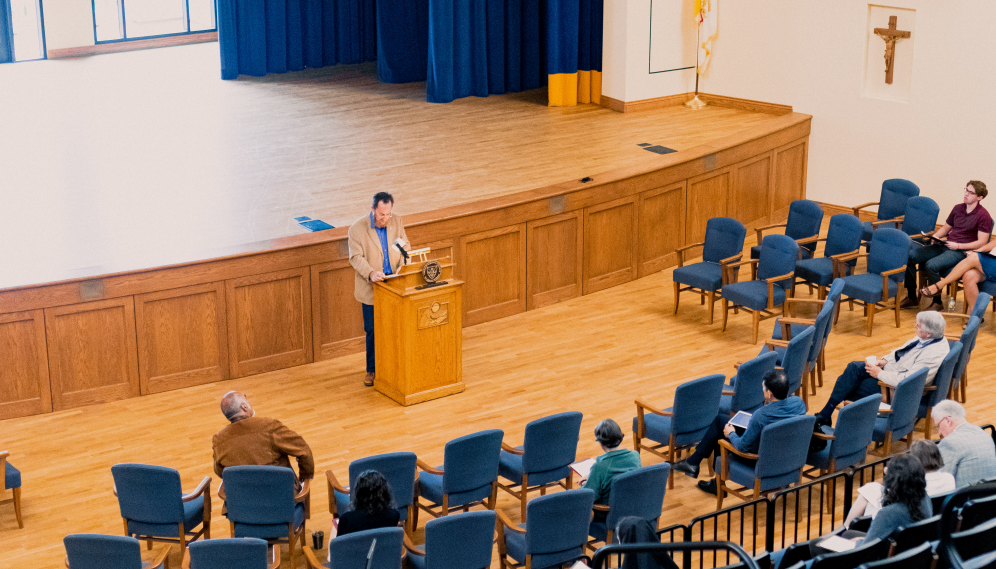 Dr. Decaen gives an address in the Auditorium