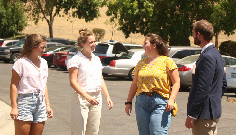 Four chat in the parking lot
