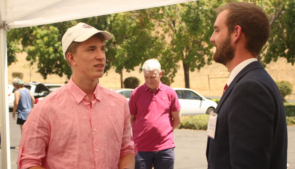 A freshman chats with a member of Admissions