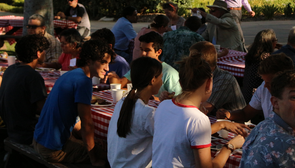 Students chat at the picnic tables