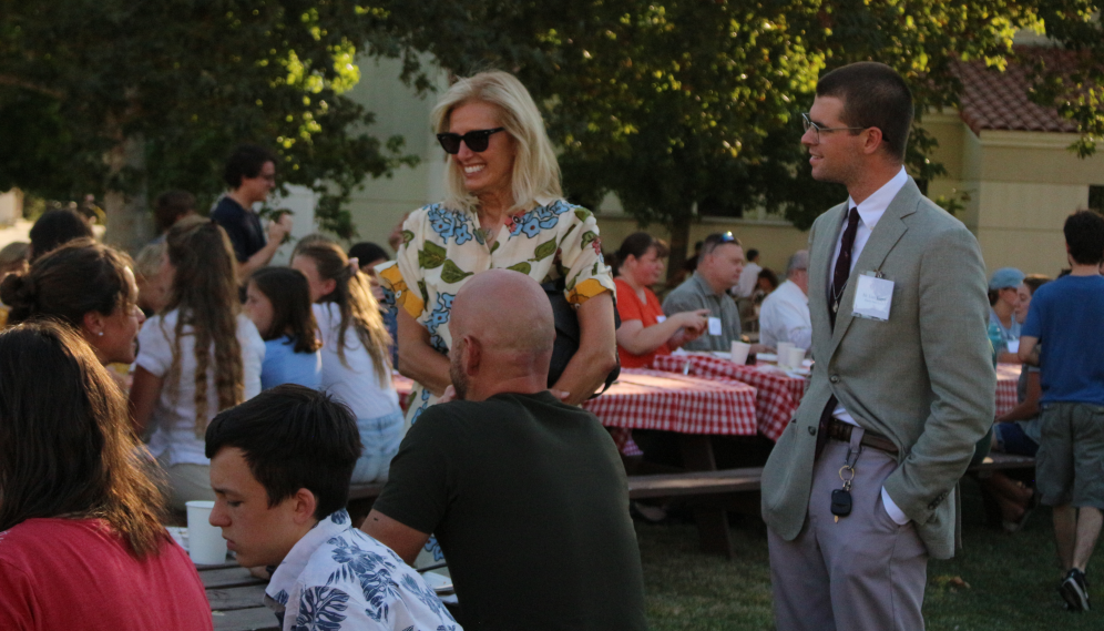 Various people chat around the tables