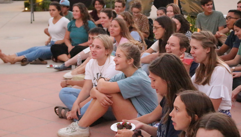 Laughing students seated, about to hear the prefects