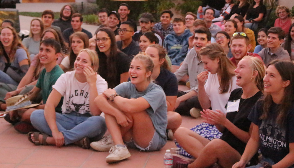The seated students laugh
