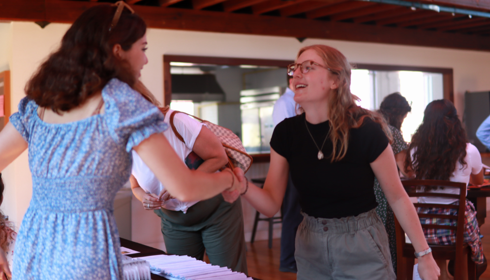 An Admissions member shakes hands with a student