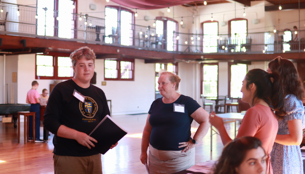 A student and his family talk with the admissions crew