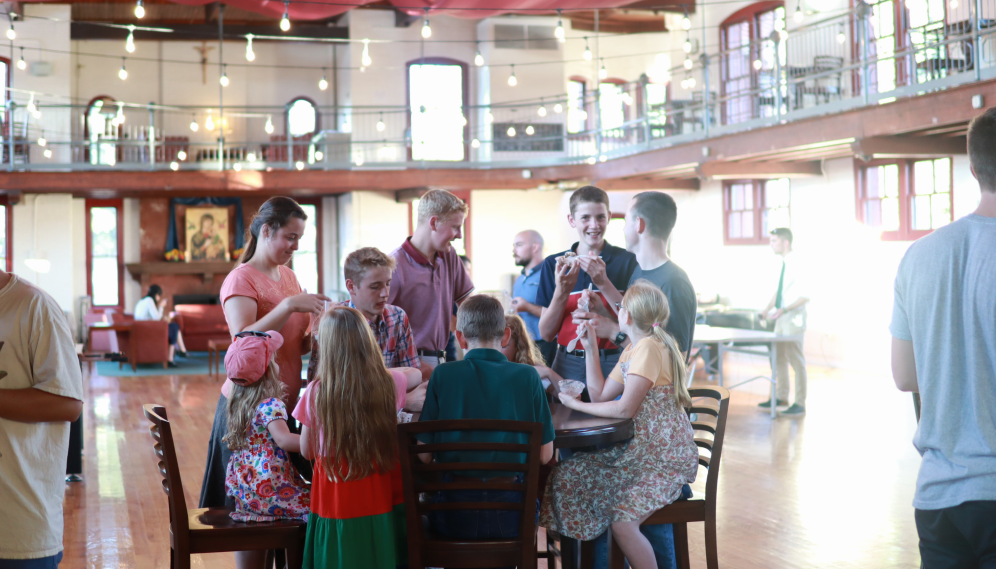 A group chats around a table in Tracy