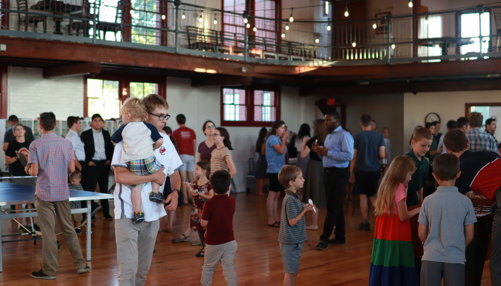 Wide shot of Tracy full of students and their families