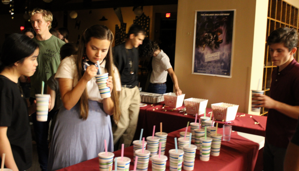 Students take drinks from the drinks table