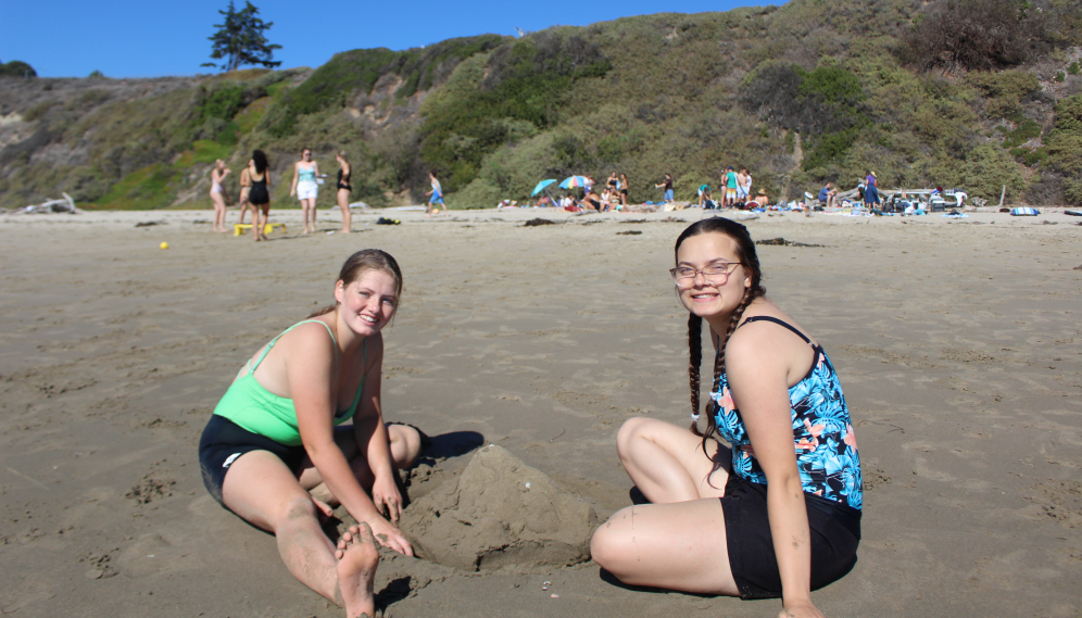 Two assemble a sandcastle