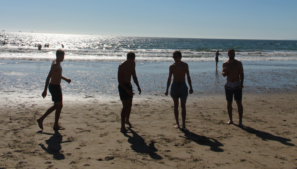 Four silhouetted against the bright water