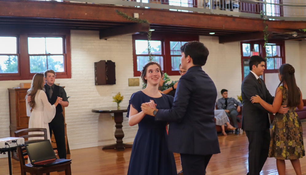 A student pair dances and chats