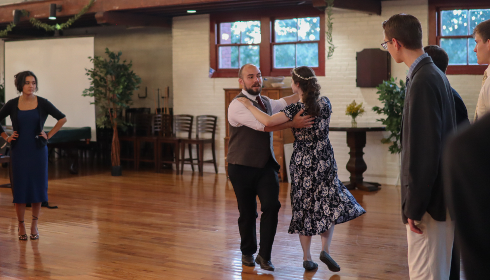 Two seniors lead a dance lesson