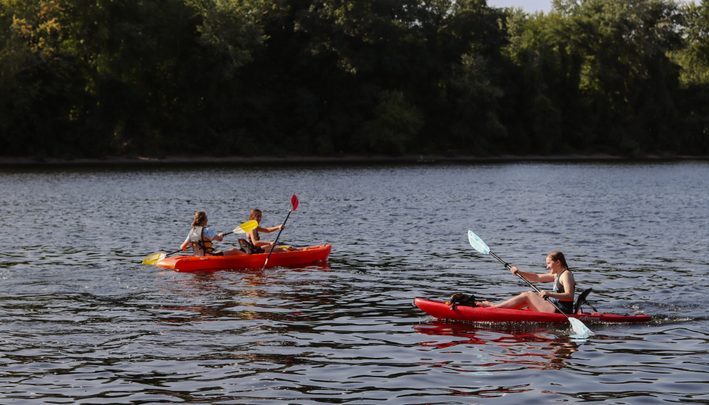 Kayakers in a single and a double kayak out on the river