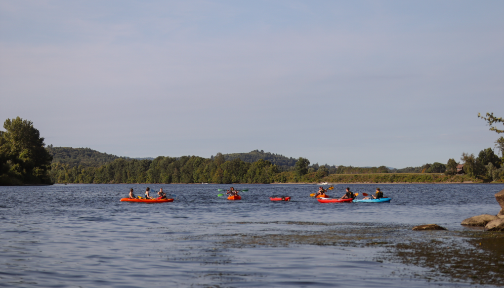 Students out on the river in their kayaks
