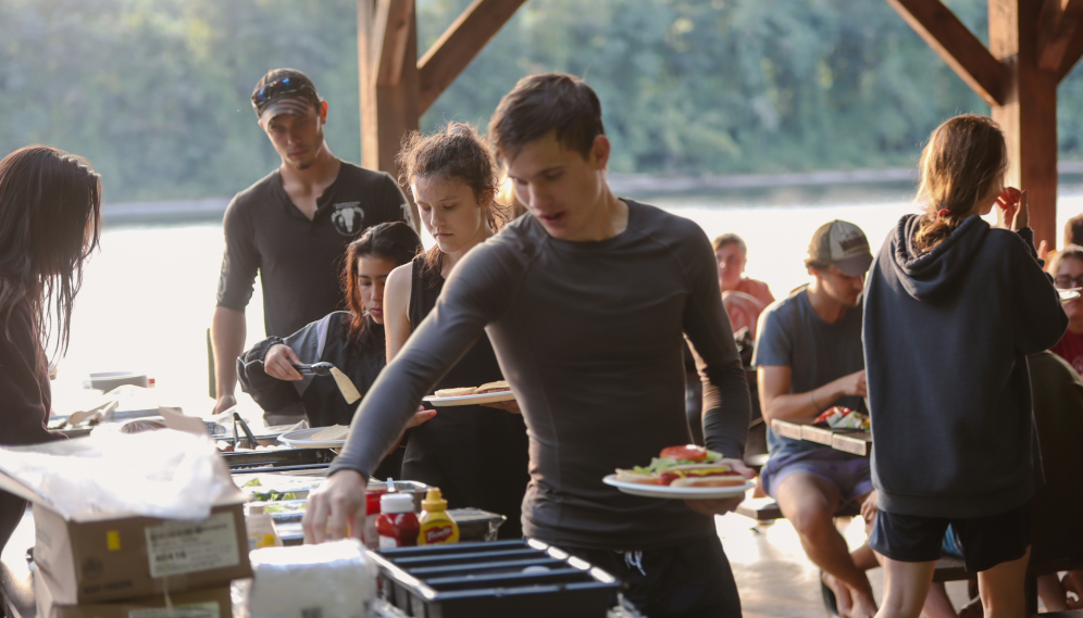 Students get their food from the buffet table