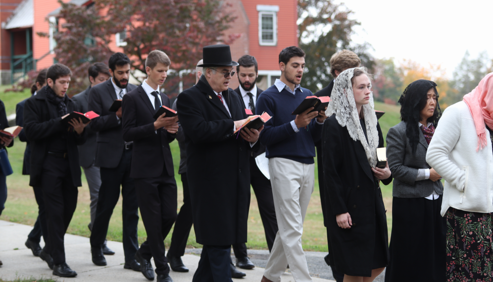 Members of the choir process from Nurse Nancy's home to the chapel, singing