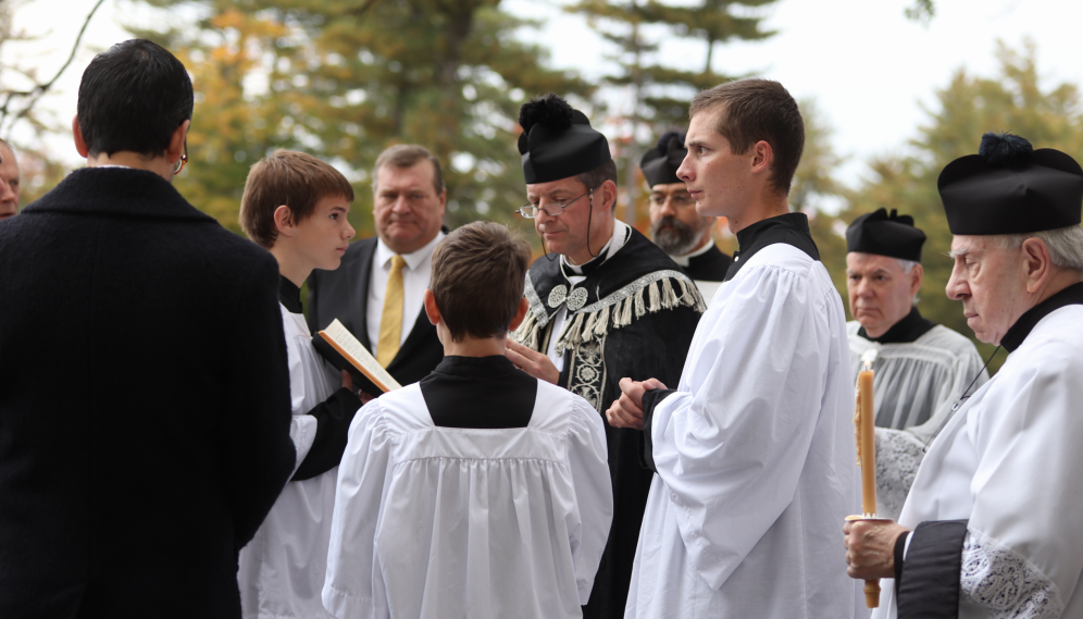 Fr. Markey performs the funeral rites