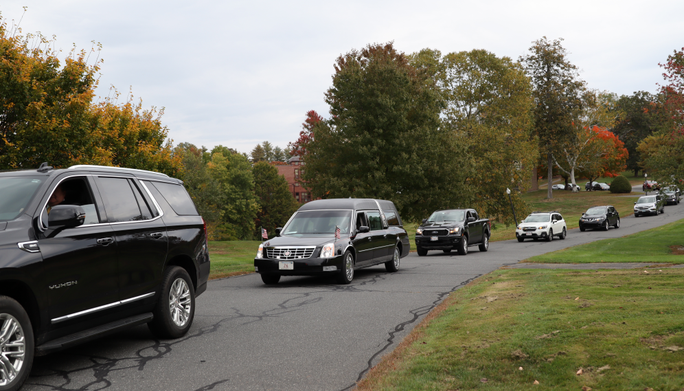 The funeral motorcade departs campus