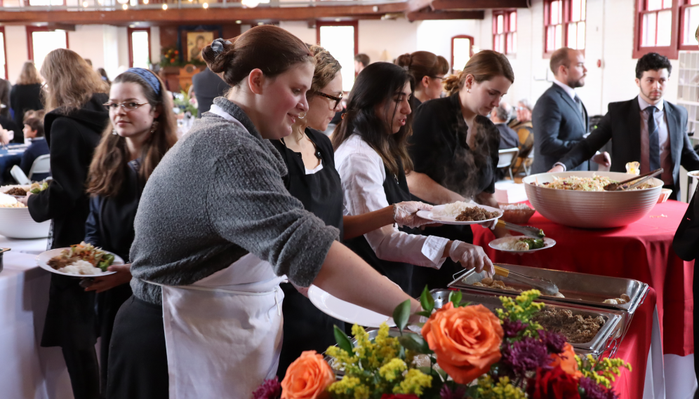 Back on campus, servers serve the funeral luncheon