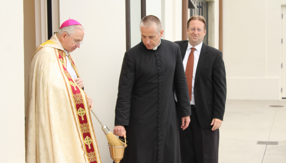 Fr. Marczewski helps the Archbishop with the aspersorium