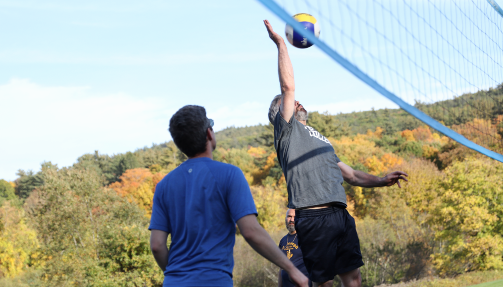 A tutor spikes the ball