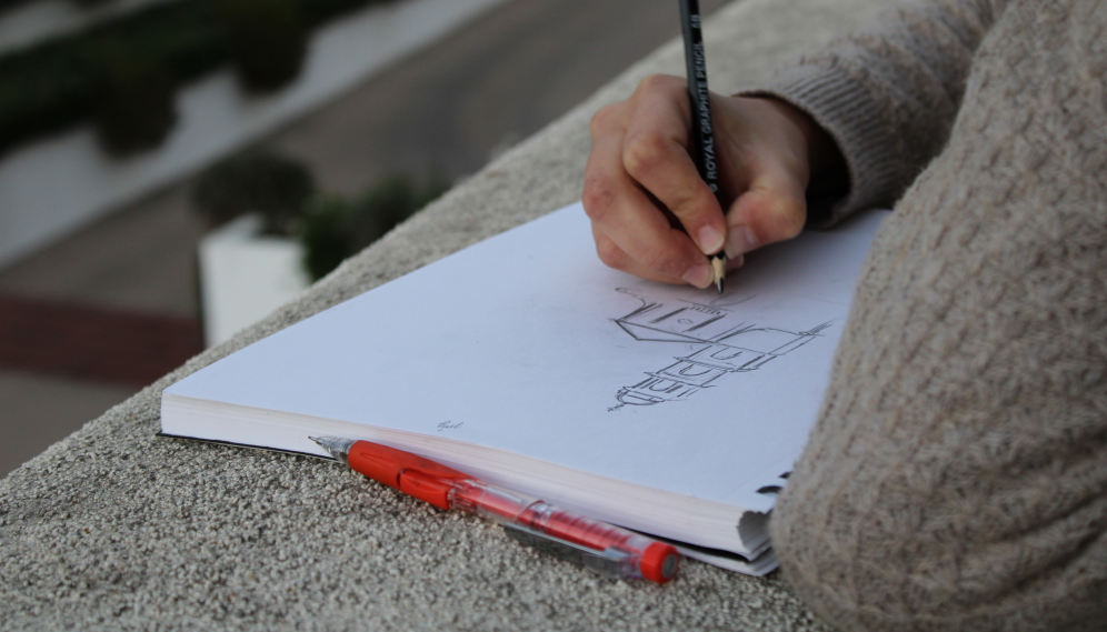 Closeup of a student's drawing pad where they are sketching the Chapel