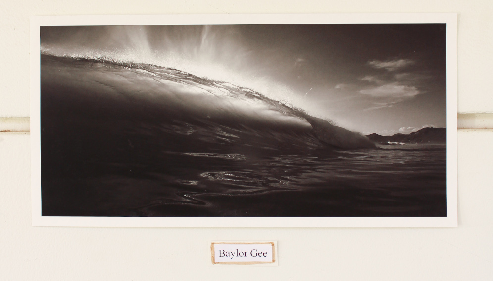 A photorealistic charcoal drawing of sunlight behind a breaking wave, by Baylor Gee